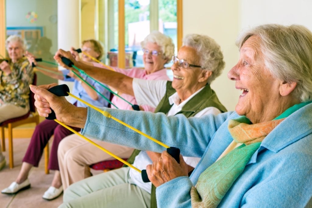 a group of senior women exercising their upper body