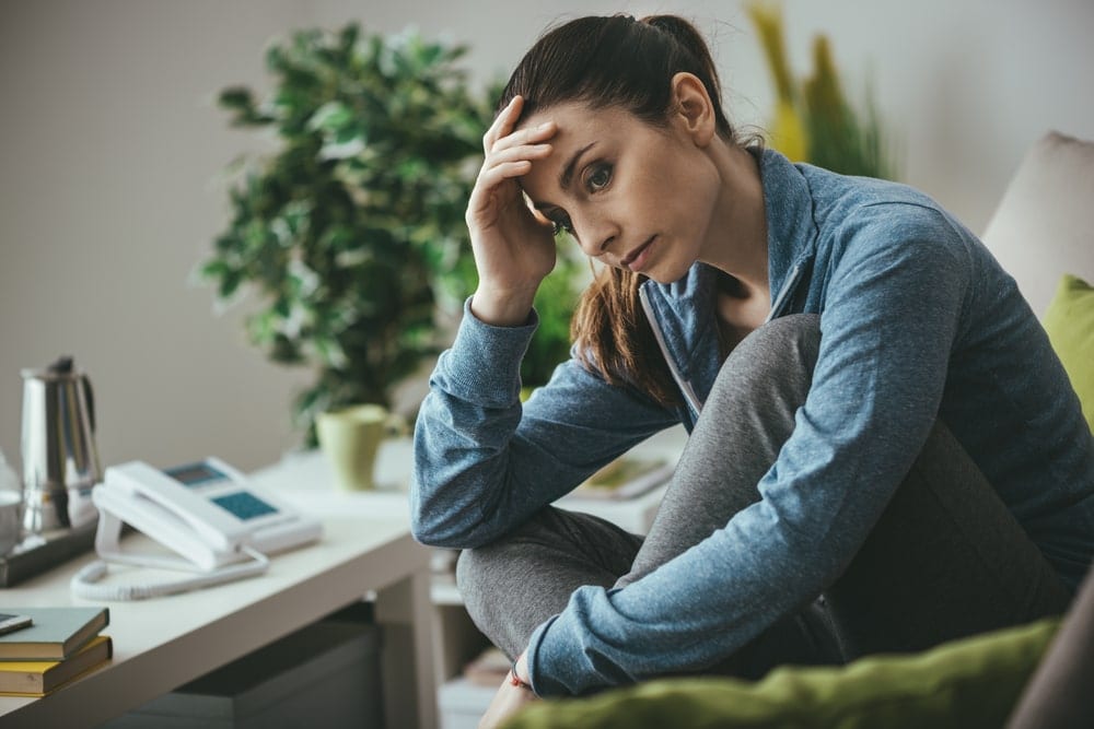 woman sitting at her desk looking lost