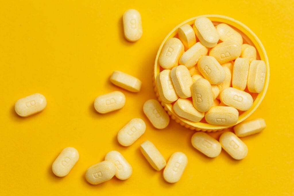 B vitamins on an orange background