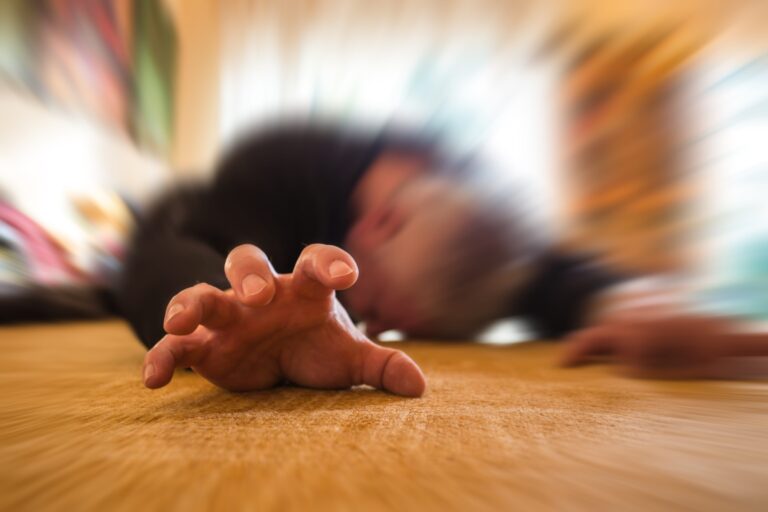 a man lies unconscious in his apartment