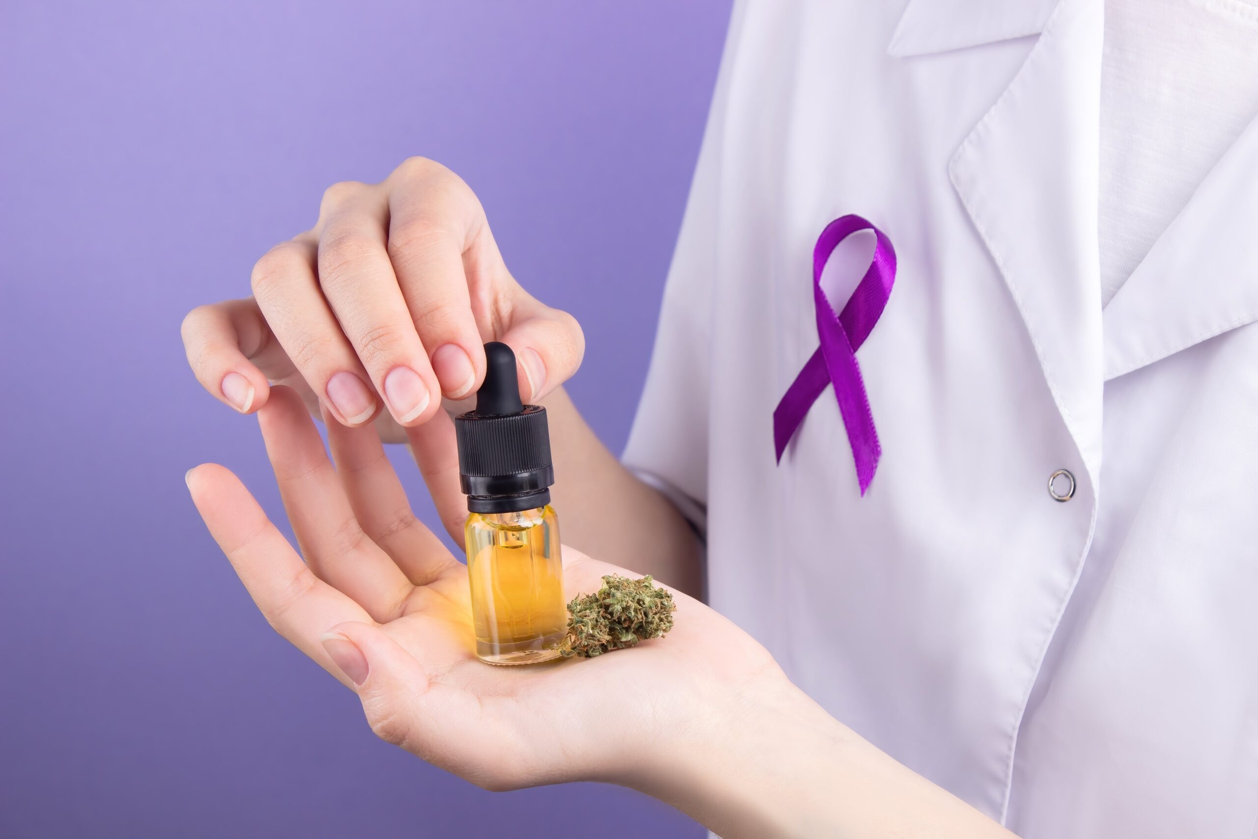In the hands of a doctor, a glass bottle with a pipette with an extract of cbd oil, in the palm of his hand, a dry bud of medical marijuana. Alternative treatment with medical cannabis.