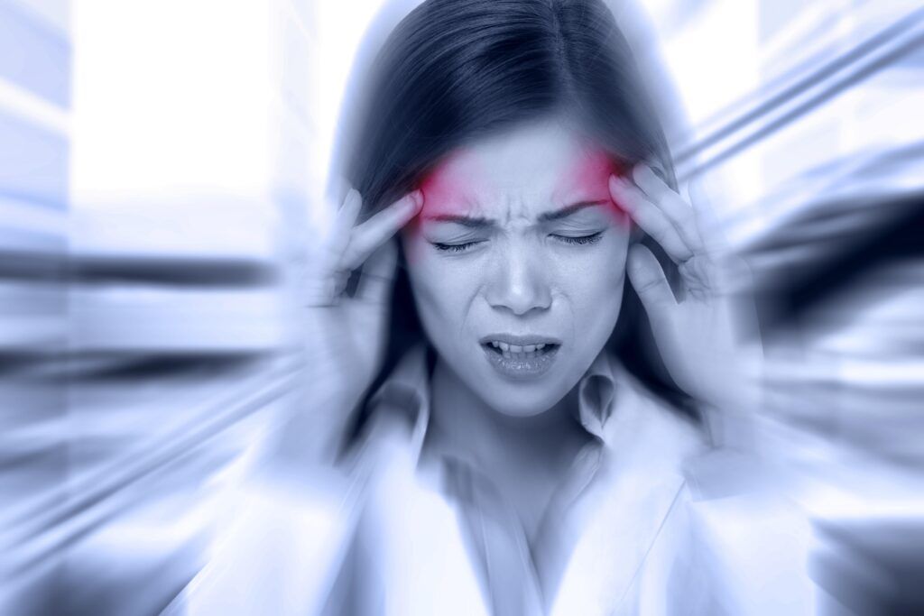 woman holding her head in pain