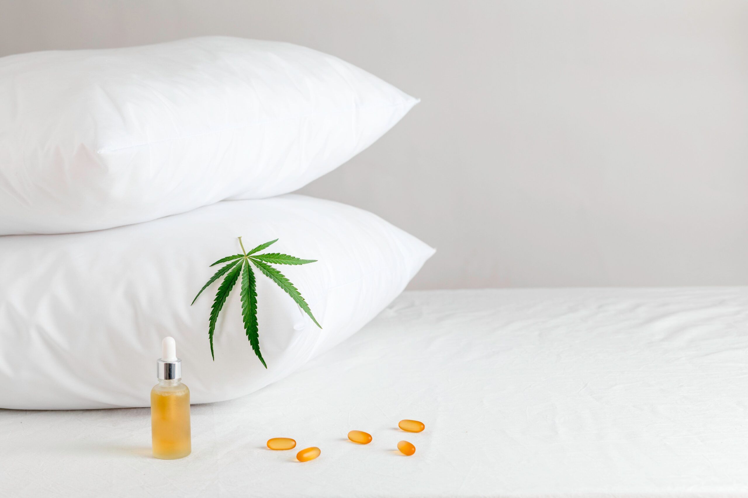 Melotonin production, pills, capsules and cbd oil on the bed. Concept sleep disorder. beat insomnia and restore sleeping routine.
