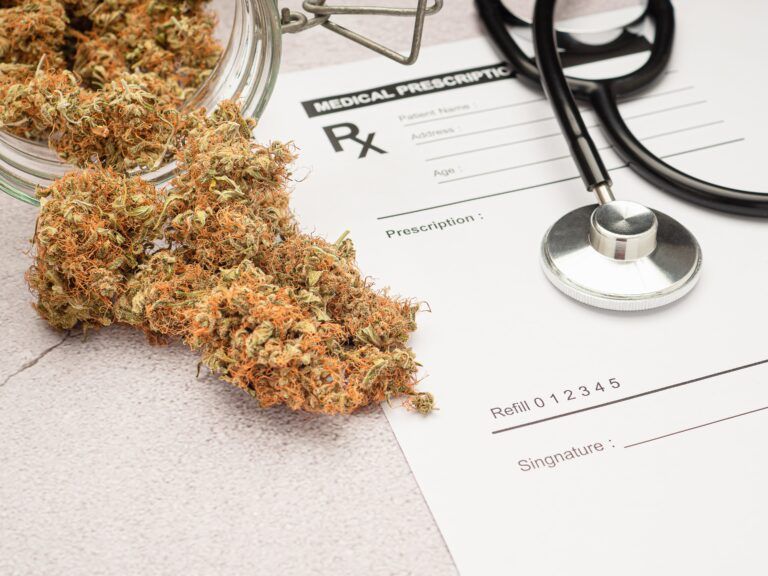A stethoscope on the medical prescription sheet and dry marijuana buds flowers. Space for text. Herbal, medical and healthcare concept